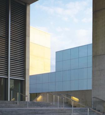 RATIONAL RESTRAINT

As seen in the framed view from the entrance stair, GRAM's exterior is an essay in restraint, with a materials palette of concrete, glass, stone, and aluminum, all kept within a narrow color range.

