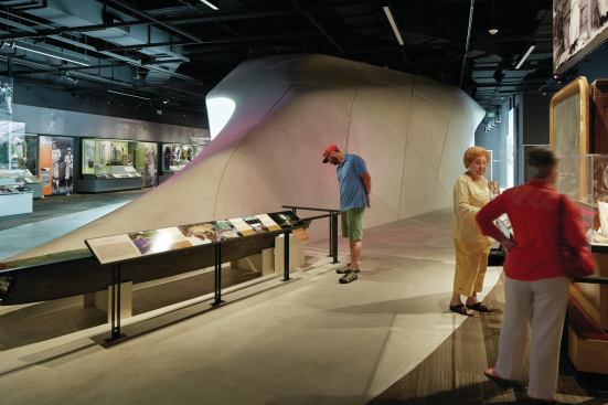 On the second floor, gallery spaces feature high ceilings with exposed HVAC ductwork from McQuay International over floors clad in Shaw Contract carpet. 