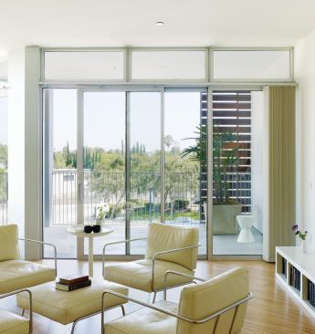 Each of the two-bedroom units along Santa Monica Boulevard is equipped with a sliding wood screen that moves along the balcony rail. The screen can be used to modulate the amount of direct sunlight reaching the living area, or to create an enclosed outdoor space, sheltering the deck from the busy thoroughfare. Flexible interior spaces can be programmed multiple ways, depending on the needs of the owner. "We were thinking about how people cohabit and thinking through different lifestyle scenarios," explains principal Julie Eizenberg. "You could use [the space] as a living room or as a live/work office. There is no right way."