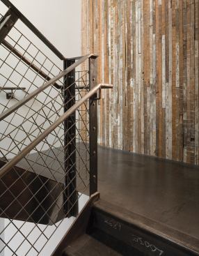 The mild steel-clad entryway of the old building, a former shoe parts warehouse, blends with the transitional neighborhood.