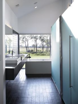 Slate tiles in a stack-bond pattern form a backdrop that allows the room's basic volume to read through.