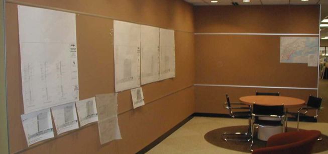 Tac-wall system Walltalkers 
www.walltalkers.com    A durable floor-to-ceiling linoleum and cork wall covering that serves as an alternative to traditional bulletin boards. Available in 12 standard colors, the material resists cracking, drying, and peeling. Color extends throughout the width of the product, better hiding standard wear and tear.