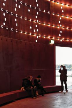 Daylight seeps through the perforations that follow the rust patterns on the walls of the former oil-storage tank.