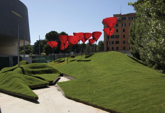 stARTT's founders Simone Capra and Claudio Castaldo greened the concrete courtyard with a series of turf-covered islands made out of straw bales and dirt. When the project is over, materials such as straw, geotextile membranes, and plastic reused for local improvements.