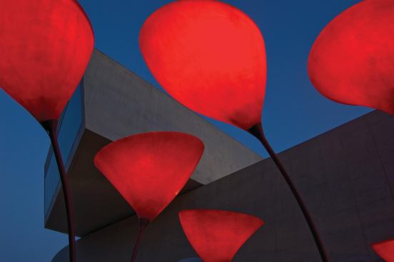 At over 16 feet tall and equipped with light fixtures, the fiberglass flowers provide shade during the day and illumination come evening.