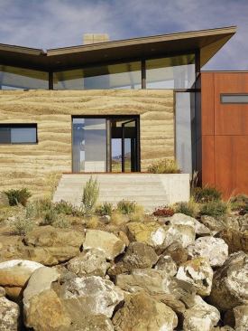 The main entry is an opening in a long rammed earth wall.