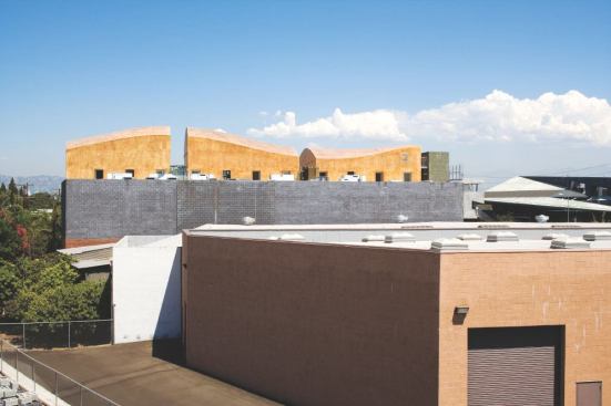 The golden-hued forms resting on top of 3555 Hayden constitute the second addition Moss has made to the building, a warehouse from the early 1950s.