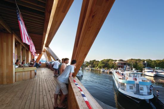 The Pavilion’s second-level terrace overlooks the harbor. Temporary OSB guardrails will be replaced by steel balustrades that will line the front of the deck. 