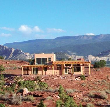 From the edge of a bluff, the 1,200- square-foot Red Rock Retreat in Torrey, Utah, takes in dramatic views of a river valley.