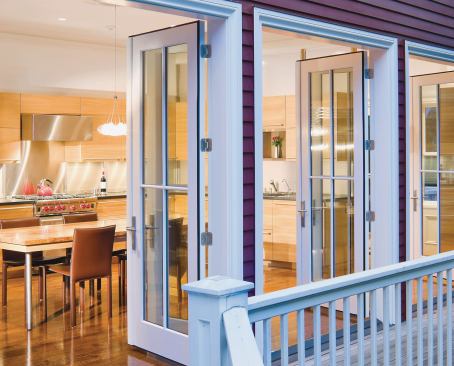 Three pairs of French doors open the kitchen to the house's side deck.