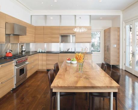 Semi-fitted cabinets allow this new kitchen to float inside a traditional space. An island top of rift-sawn elm contrasts with the quieter grain of the casework.