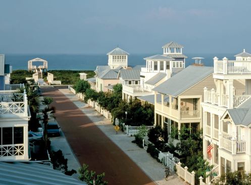 Picturesque cottages and townhouses line the streets of Seaside, Fla., one of DPZ’s earliest projects. 