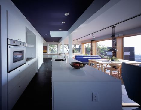 The three companion houses changed the neglected property's density, thus fitting it into the larger community. The kitchen in Salmela's home overlooks Duluth and its harbor.