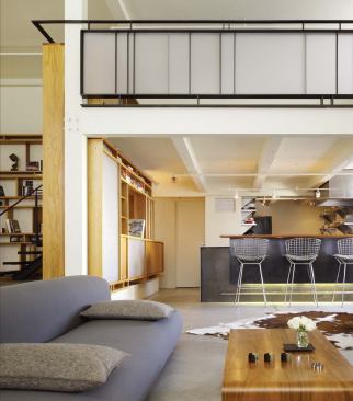 A bilevel island, known as the Stage, provides some separation between the living room and the kitchen.