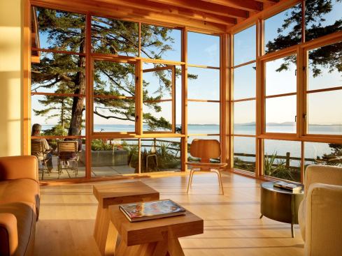 Floor-to-ceiling wood windows maximize water views from the living room.