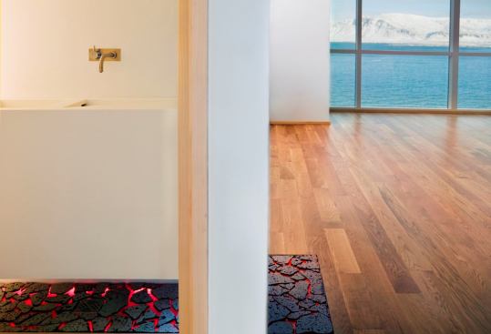 A black lava rock detail flows unobtrusively from wall to floor in the kitchen and bathroom.