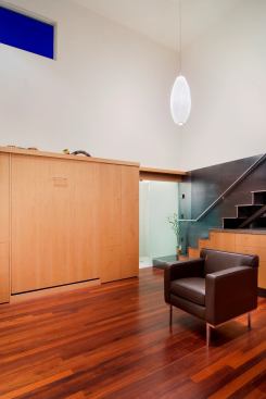 A Murphy bed adds master suite to the list of uses already in play for this open kitchen/dining/living space.