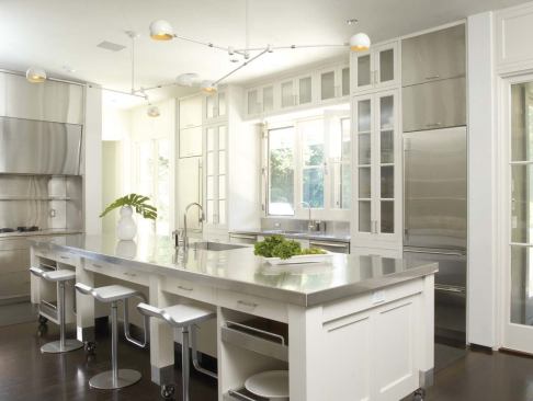 2009 Kitchen/Merit: Riverbank Residence, Stamford, Conn., by Joeb + Partners, Architects, Greenwich, Conn.  Striking contrasts —ebonized floors and white cabinets, a mobile island and fixed appliances, contemporary stainless steel and traditional wood —punctuate the elegant room.