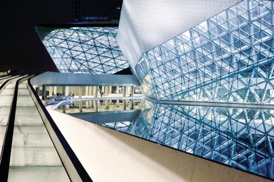The Guangzhou Opera House is a complex of two buildings: the main 1,804-seat theater (at left) and a 443-seat multipurpose space (at right).