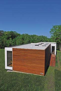 Modular 4's white roof reflects the sun's heat, providing a passive cooling effect. Siding consists of Brazilian hardwood and recycled aluminum panels.