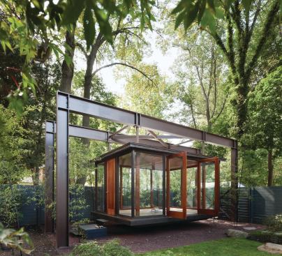 A 4-inch-thick wood entry door welcomes visitors to the pavilion, used as a tea house, meditation room, and stage for family musical performances.