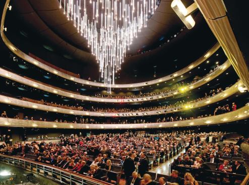 The drum houses a traditional horseshoe-shaped theater with an acrylic-rod chandelier that retracts when performances start.