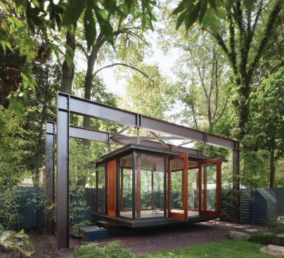 A 4-inch-thick wood entry door welcomes visitors to the pavilion, used as a tea house, meditation room, and stage for family musical performances.