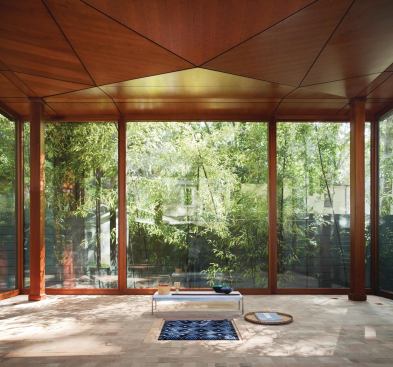 The floor is made from the exposed end blocks of vertical-grain Douglas fir. The ceiling folds down in the middle, like a dreidel, and echoes the steel cross-bracing.