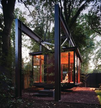 A folded steel origami stair is suspended in a poured concrete plinth.