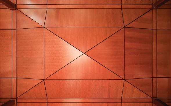 The patterned cherry ceiling evokes an abstracted tatami mat.
