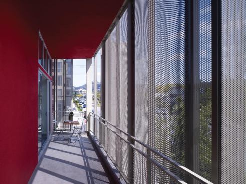 The spaces between the building’s structure and skin serve as private porches.
