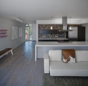 Kitchen backsplashes of recycled skateboards represent one of many environmentally friendly material choices. Energy-efficient strategies such as green roofs, a reflective roof, solar panels, and cellulose insulation (among others) should also help the building achieve LEED Platinum status, according to Brooks + Scarpa.
