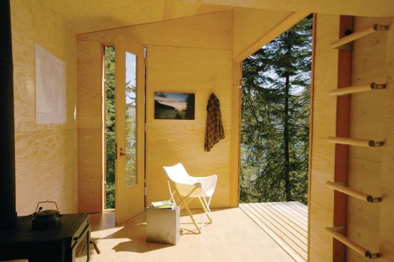 Built with recycled materials, the structure features an 8-foot-tall barn door, a wood stove, and laminate floors.