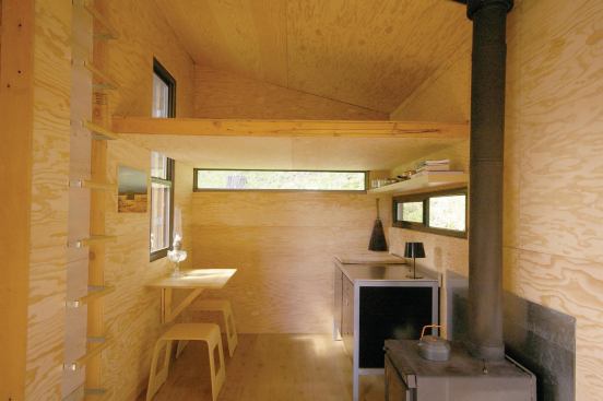 The kitchen is as sparse as the rest of the shed, with Ikea cabinets and plywood wall paneling.