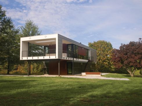 Mahogany panels warm the metal and fiber-cement exterior.