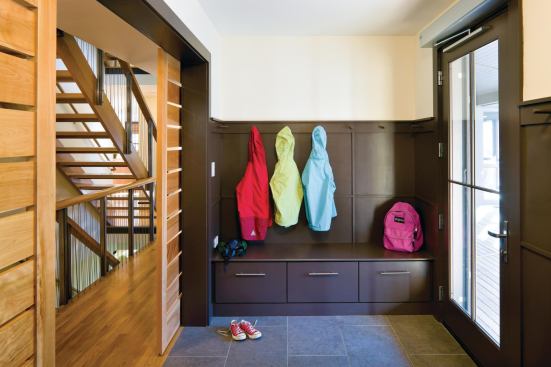 Equipped with an automatic door opener, a wheelchair charging station, and a durable ceramic floor, the mudroom is the main point of entry for all family members. Residents and visitors store shoes here to avoid tracking mud inside as a way to reduce indoor contaminants. In addition, a nearby outdoor faucet allows for easy cleaning of wheelchair tires.