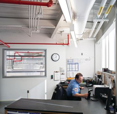 The second-floor Lieutenant’s office  serves as a command center and allows (via an internal window) for oversight of the vehicle bay on the ground floor. 