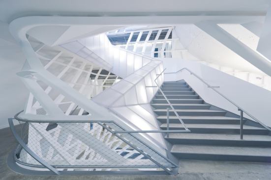 A 20-foot-wide grand stair rises four stories through the skylit atrium. 