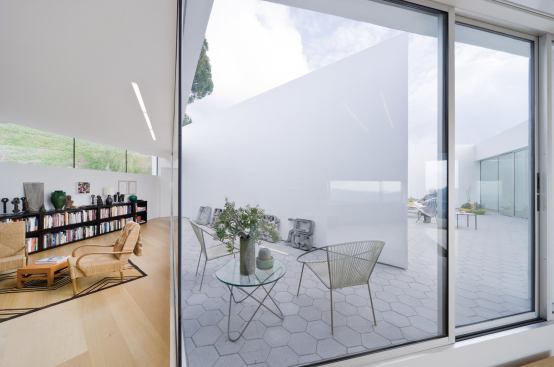 The living spaces enclose an outdoor room at the center. 
