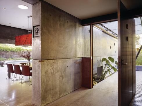 The house features a zinc-clad, pivoting front door.