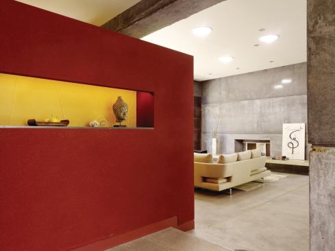 The front door leads to a foyer defined by a bright, Japanese plaster-covered wall. 

