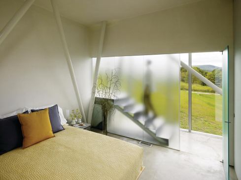 Etched glass "storefronts" allow the three bedrooms to borrow light from the corridor.