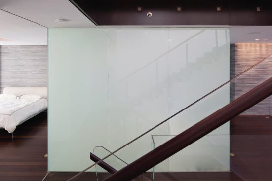 With the flick of a switch, the three glass walls of the master bath turn opaque.