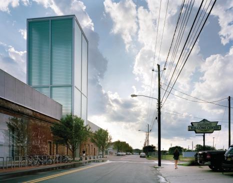 The tower rises from grade on the building’s north side and is composed of individual interlocking structural glass channels. Each glass channel is held in place with mechanical clips and then sealed with clear silicone.