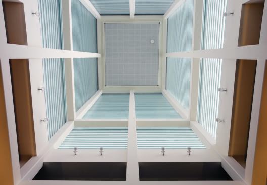 View into the channel-glass-enclosed tower from the museum lobby.