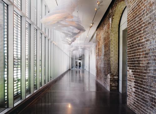 Inside the museum, the louver-covered southern façade encloses a hallway and runs the length of the 65,000-square-foot addition. This passage admits daylight and offers access to many of the new galleries, which are demarcated by arches preserved from the walls of the 1853 rail depot. The depot and existing museum building are National Historic Landmarks.