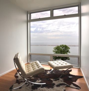 A cantilevered observatory serves as a small home office with a view. It also includes a small built in desk.