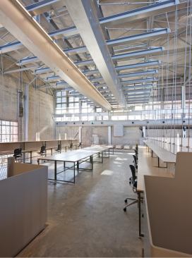 The design team repurposed an existing historic crane in the high-bay area of the Hinman Building so that it now hangs a mezzanine that expanded the building's usable space by 1,500 square feet.