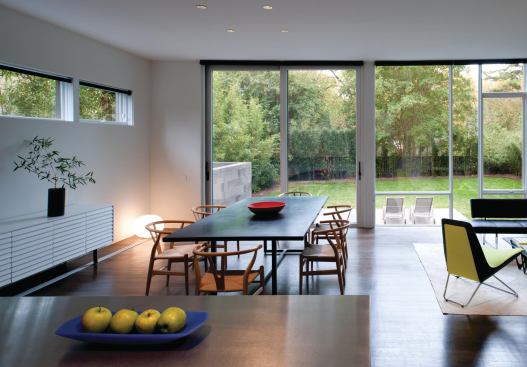 An open kitchen and dining area preserve views to the backyard.