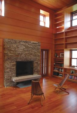The stone fireplace wall echoes the sites existing fieldstone walls. 


